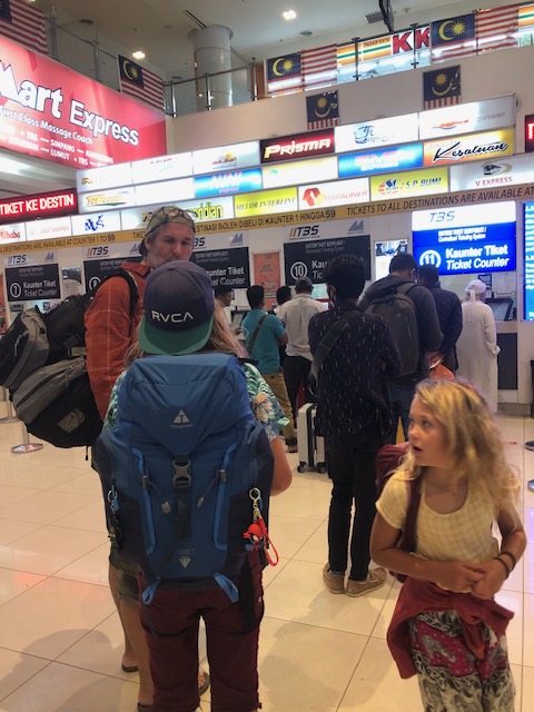 backpacking family at bus station
